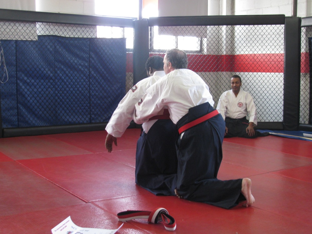 Shihan Henderson Places The Shihan Belt on Shihan York.